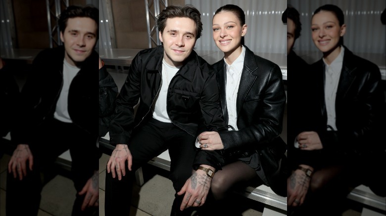 Brooklyn Beckham e Nicola Peltz seduti a una sfilata di moda