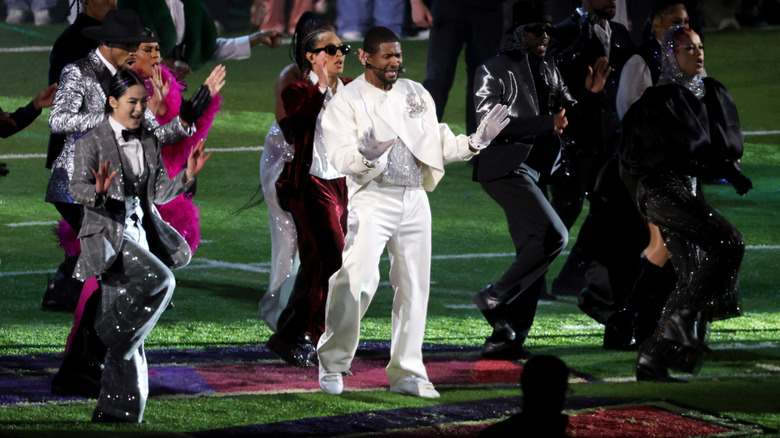 Usher si esibisce con i ballerini sul campo del Super Bowl